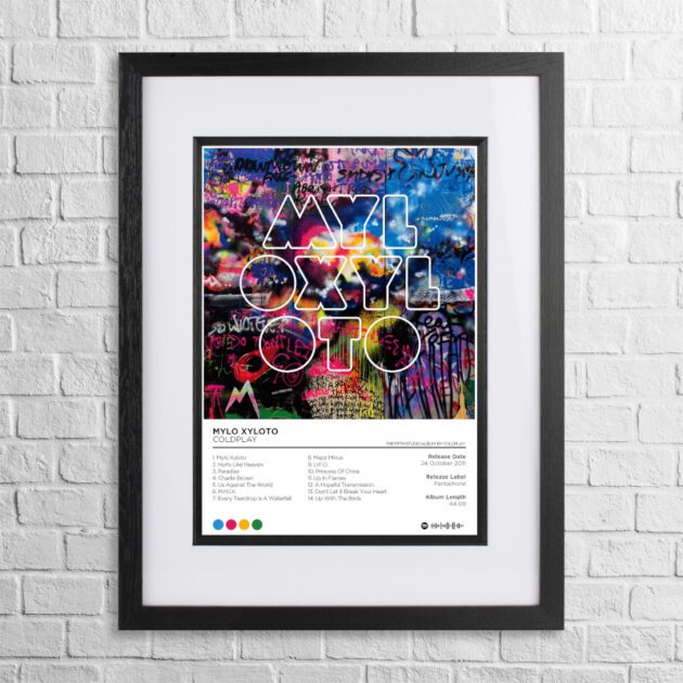 A4 custom design poster of Coldplay - Mylo Xyloto in a black, dual-aspect frame on a white brick background