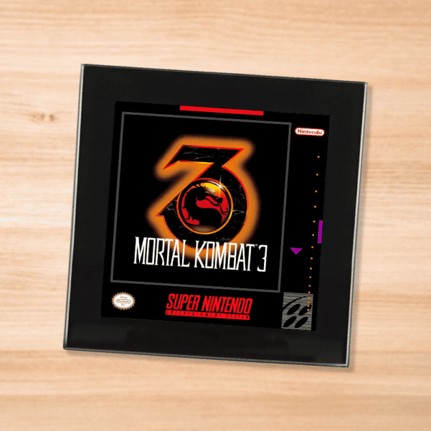 Black glass Mortal Kombat 3 coaster on a wood table