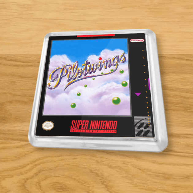 Plastic Pilotwings coaster on a wood table