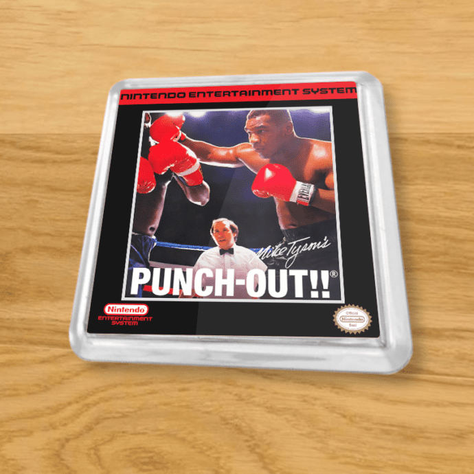 Plastic Mike Tyson's Punch-Out coaster on a wood table