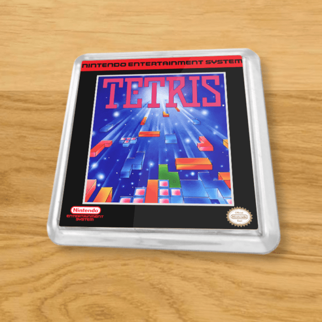 Plastic Tetris coaster on a wood table