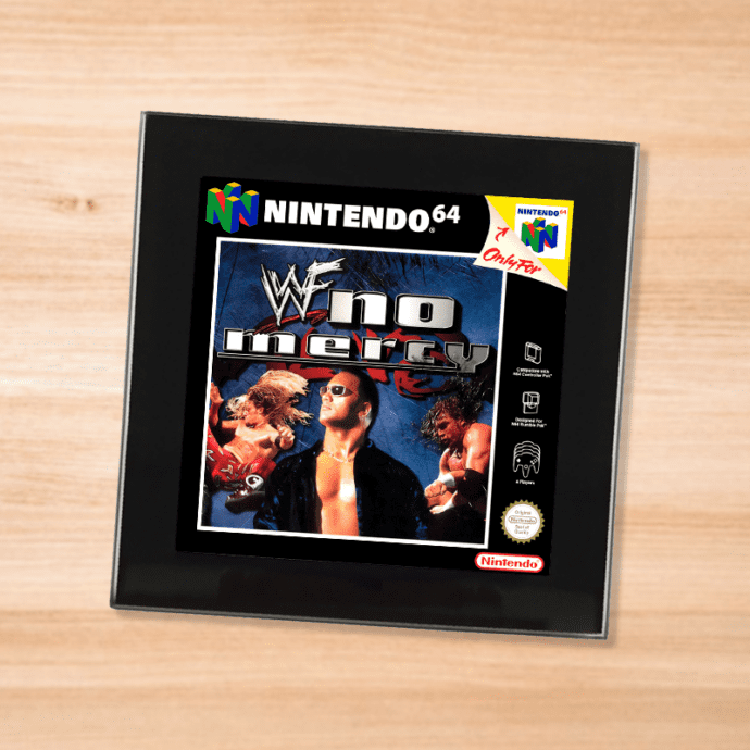 Black glass WWF No Mercy coaster on a wood table
