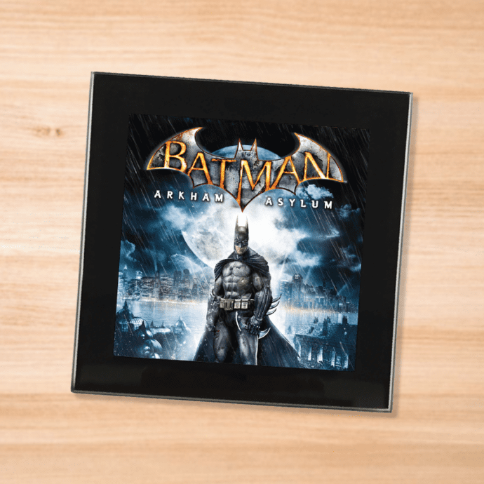 Black glass Batman Arkham Asylum coaster on a wood table