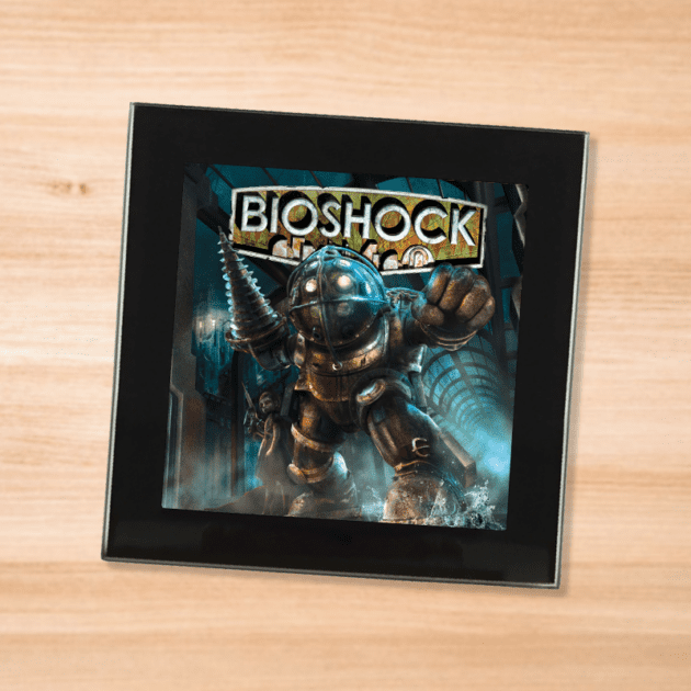 Black glass Bioshock coaster on a wood table