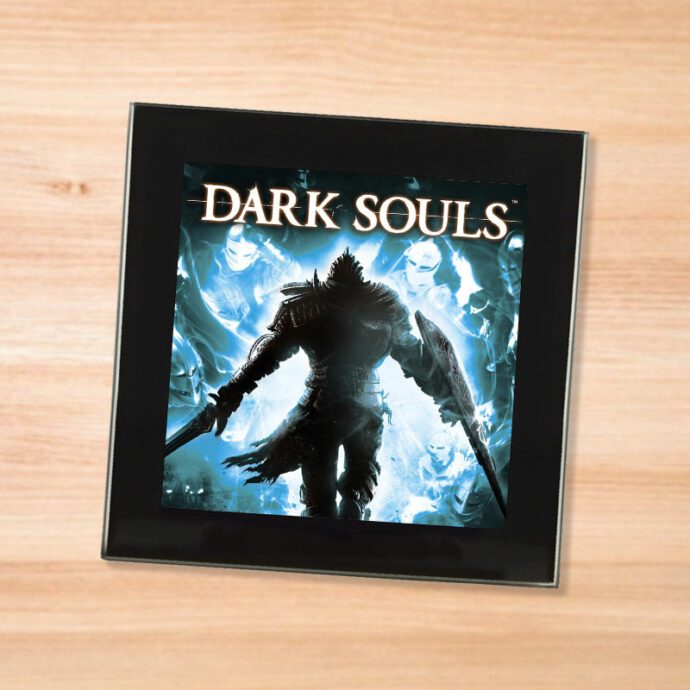 Black glass Dark Souls coaster on a wood table