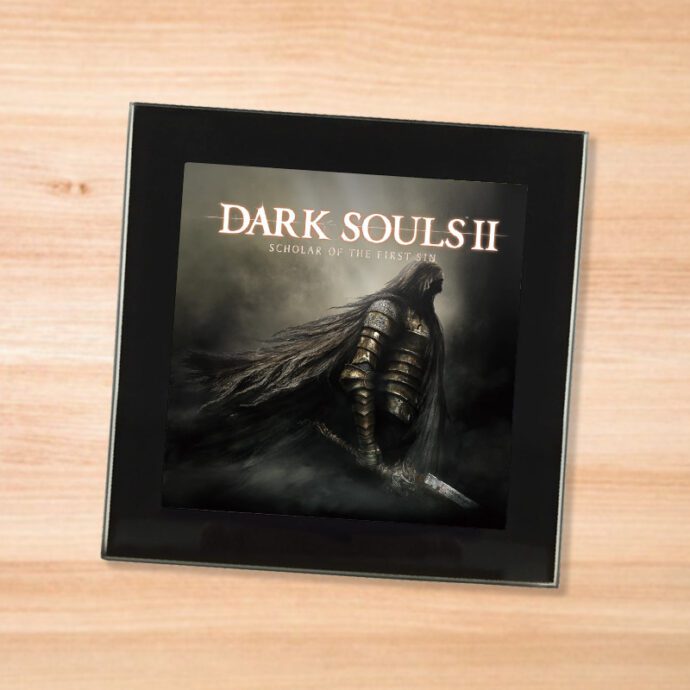 Black glass Dark Souls 2 coaster on a wood table
