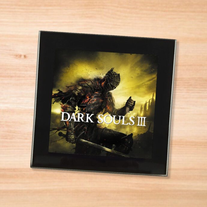 Black glass Dark Souls 3 coaster on a wood table