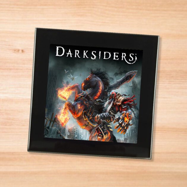Black glass Darksiders coaster on a wood table