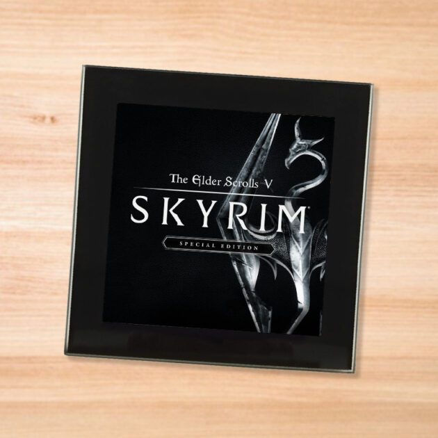 Black glass Elder Scrolls 5 Skyrim coaster on a wood table