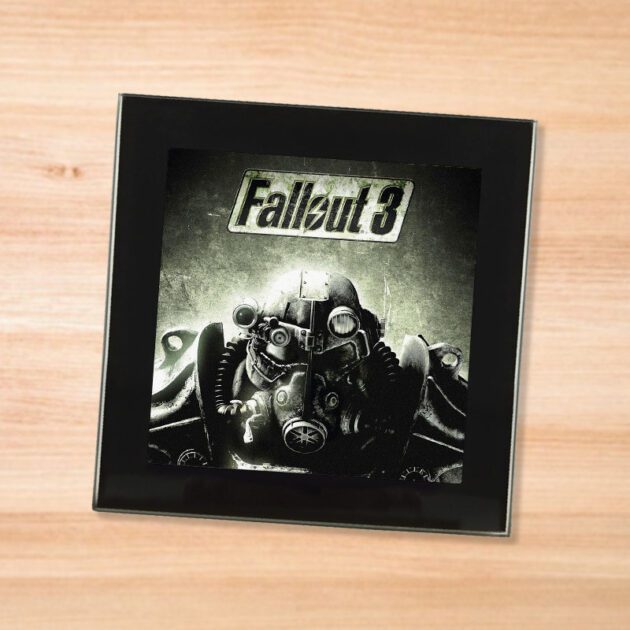 Black glass Fallout 3 coaster on a wood table