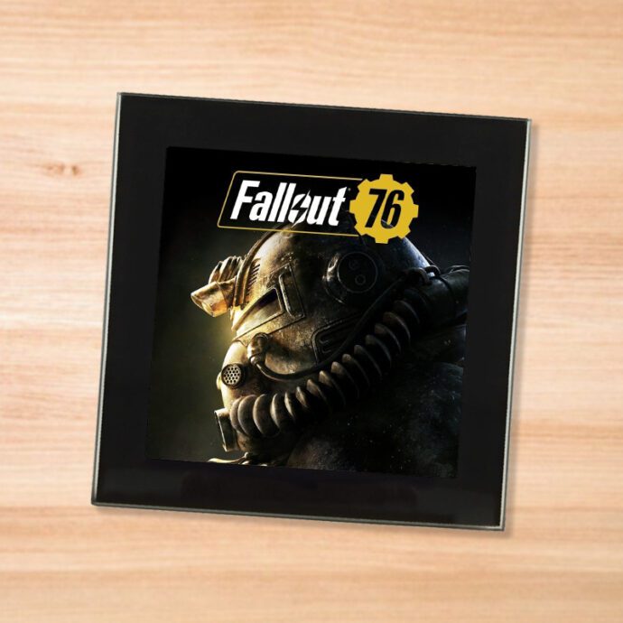 Black glass Fallout 76 coaster on a wood table