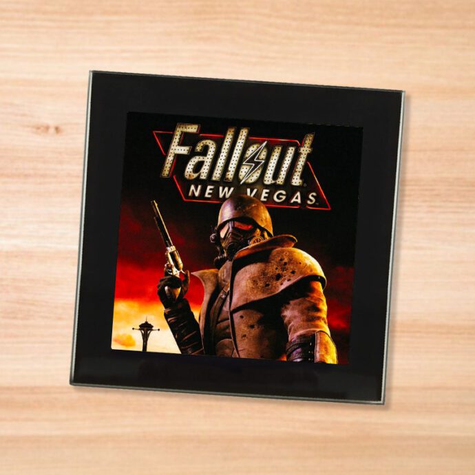 Black glass Fallout New Vegas coaster on a wood table