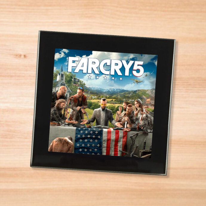 Black glass Far Cry 5 coaster on a wood table