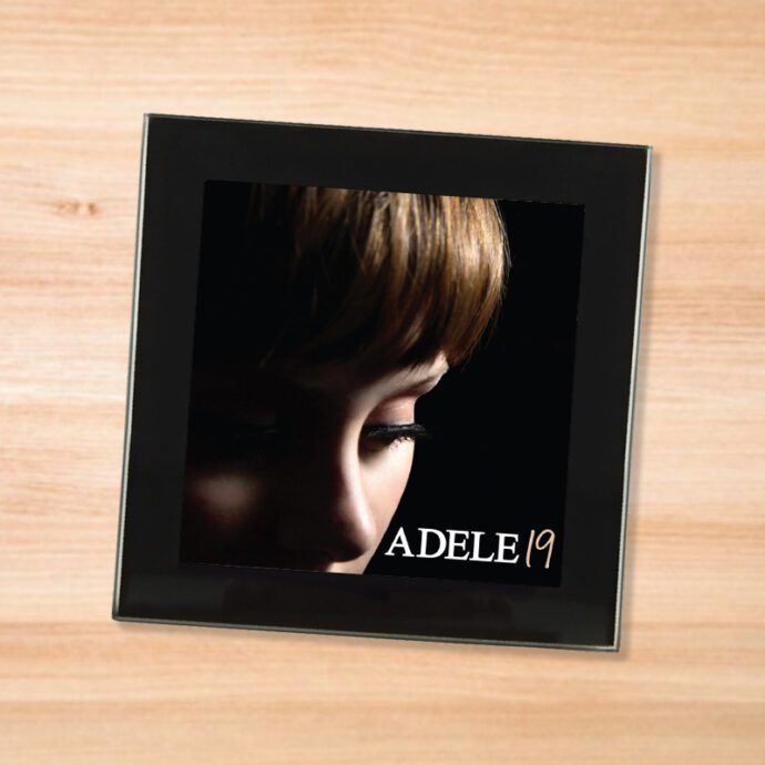 Black glass Adele - 19 coaster on a wood table