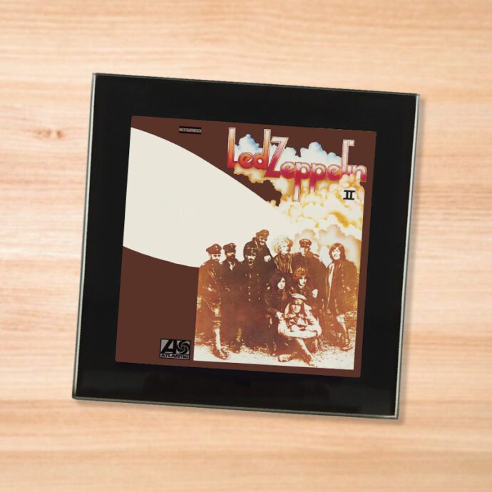 Black glass Led Zeppelin - II coaster on a wood table