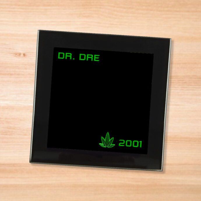 Black glass Dr. Dre - 2001 coaster on a wood table
