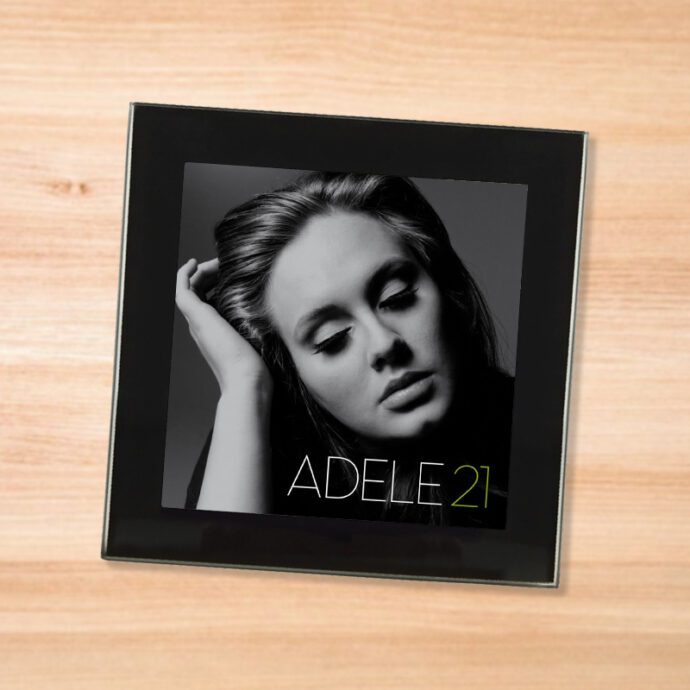 Black glass Adele - 21 coaster on a wood table