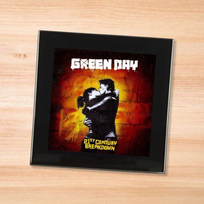 Black glass Green Day - 21st Century Breakdown coaster on a wood table