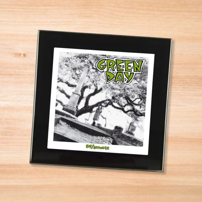 Black glass Green Day - 39/Smooth coaster on a wood table