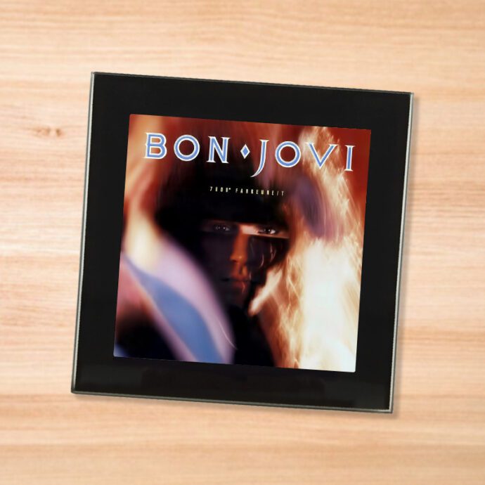 Black glass Bon Jovi - 7800 F coaster on a wood table