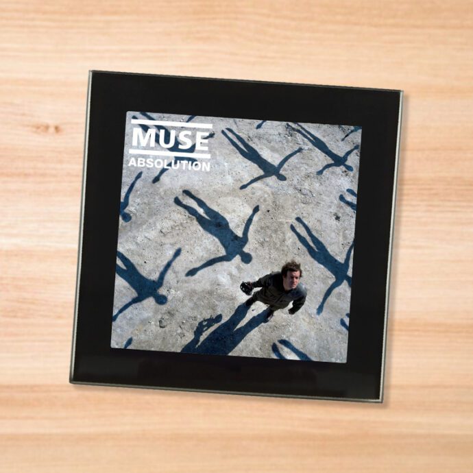 Black glass Muse - Absolution coaster on a wood table