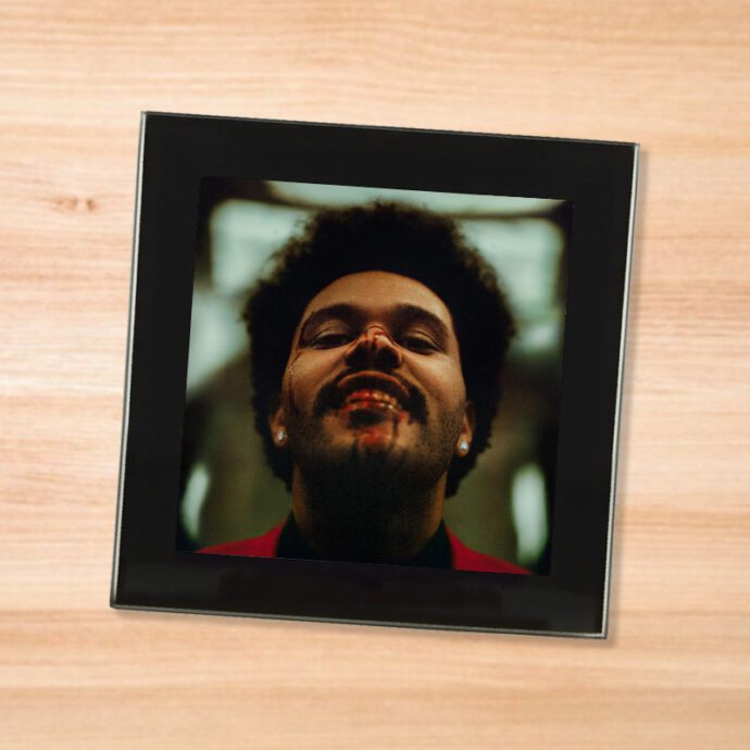 Black glass The Weeknd - After Hours coaster on a wood table