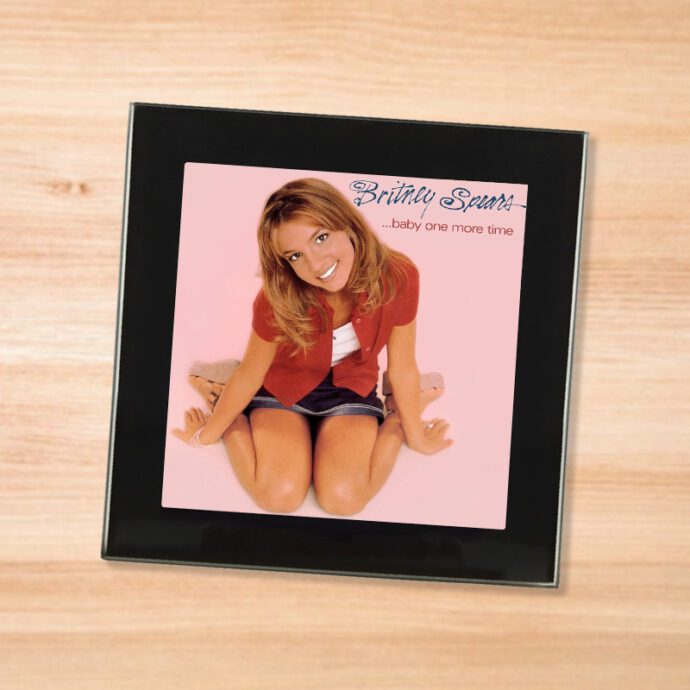 Black glass Britney Spears - Baby One More Time coaster on a wood table