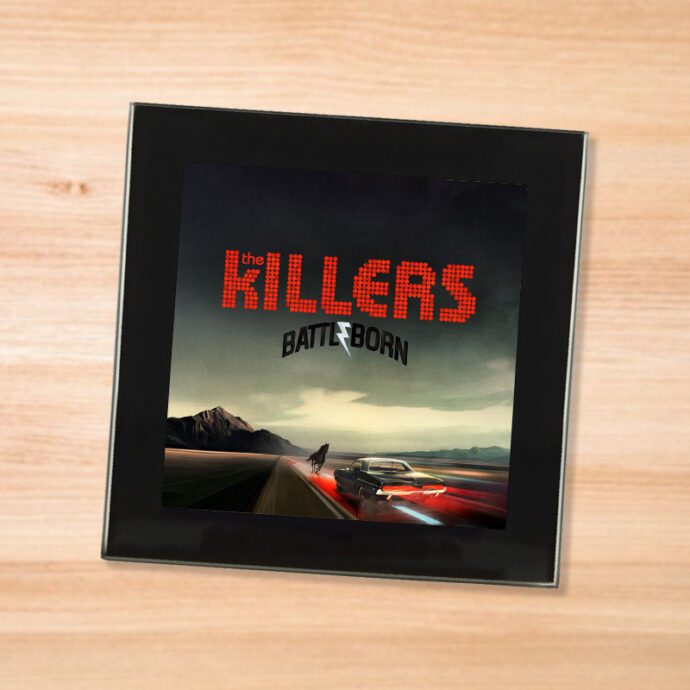 Black glass The Killers - Battleborn coaster on a wood table