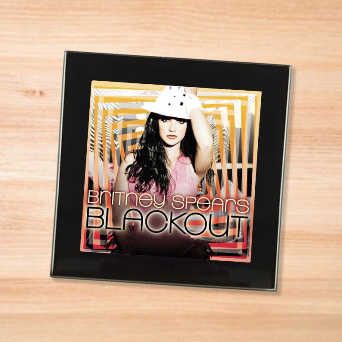 Black glass Britney Spears - Blackout coaster on a wood table