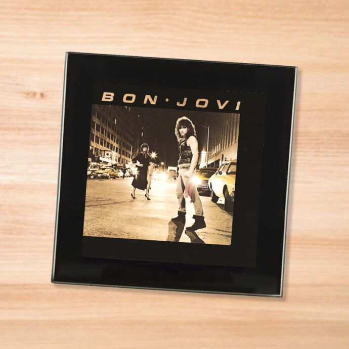 Black glass Bon Jovi - Bon Jovi coaster on a wood table