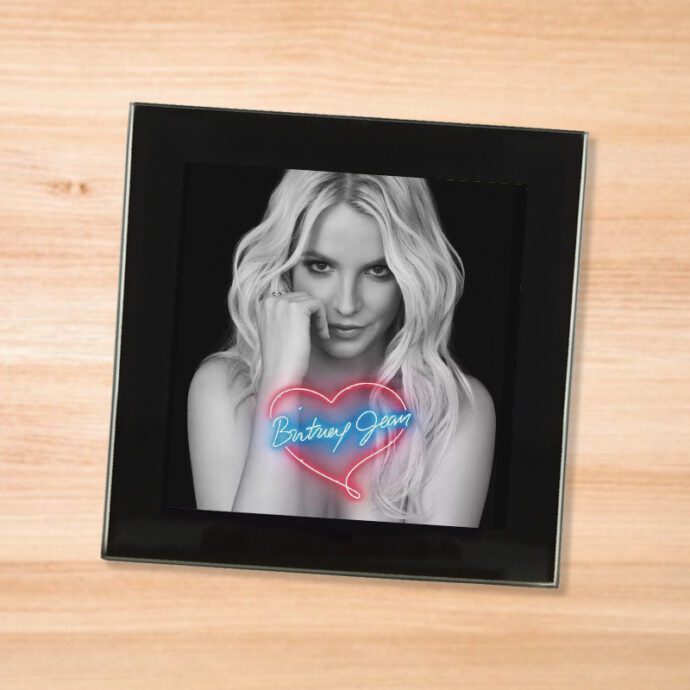 Black glass Britney Spears - Britney Jean coaster on a wood table