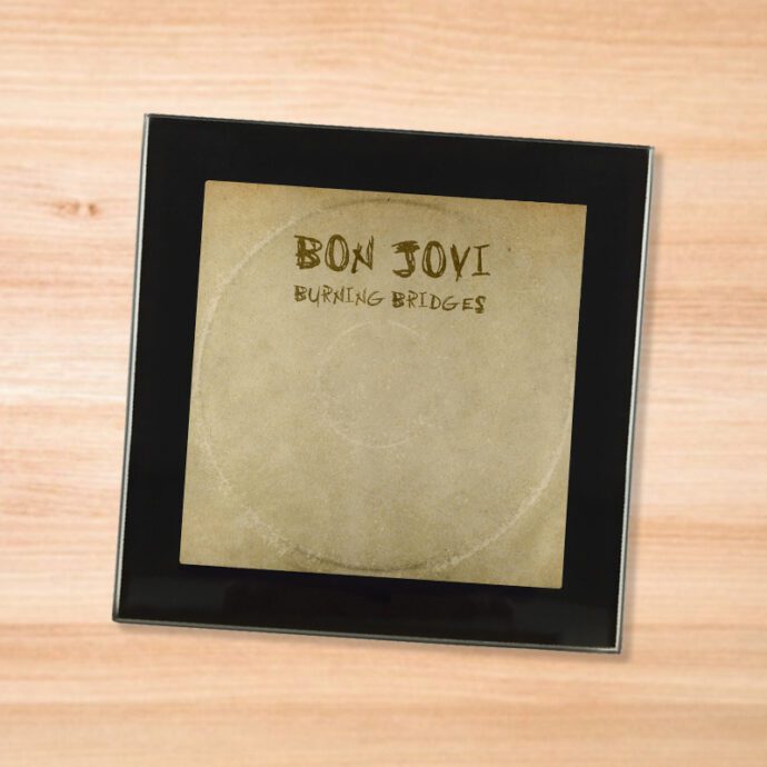 Black glass Bon Jovi - Burning Bridges coaster on a wood table