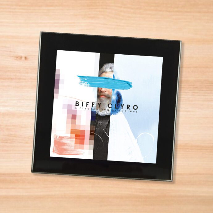 Black glass Biffy Clyro - Celebration of Endings coaster on a wood table