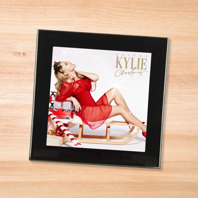 Black glass Kylie - Christmas coaster on a wood table