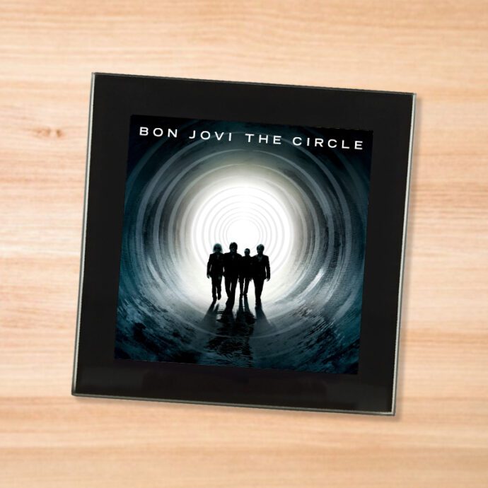 Black glass Bon Jovi - The Circle coaster on a wood table