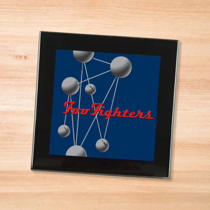 Black glass Foo Fighters - Color and the Shape coaster on a wood table