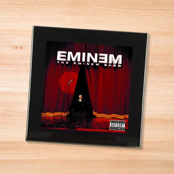 Black glass Eminem - Eminem Show coaster on a wood table