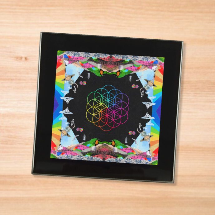 Black glass Coldplay - Headful of Dreams coaster on a wood table