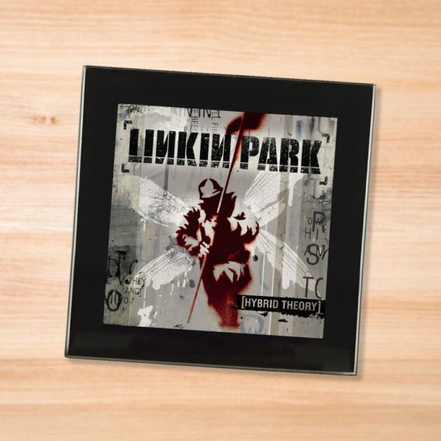 Black glass Linkin Park - Hybrid Theory coaster on a wood table