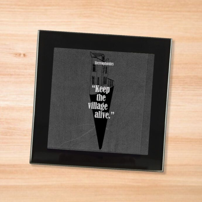 Black glass Stereophonics - Keep The Village Alive coaster on a wood table