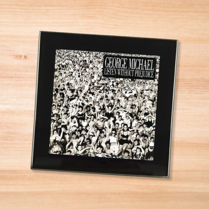 Black glass George Michael - Listen Without Prejudice coaster on a wood table