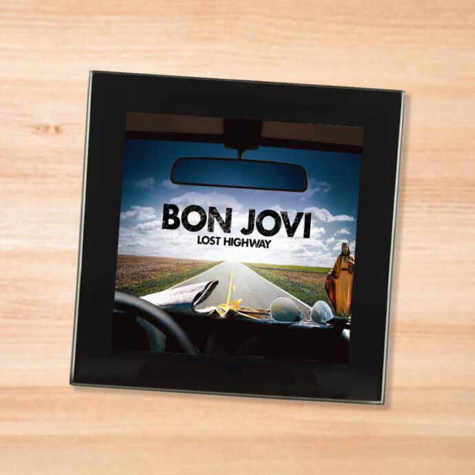 Black glass Bon Jovi - Lost Highway coaster on a wood table