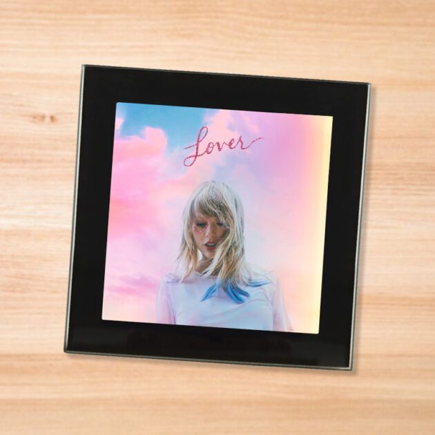 Black glass Taylor Swift - Lover coaster on a wood table
