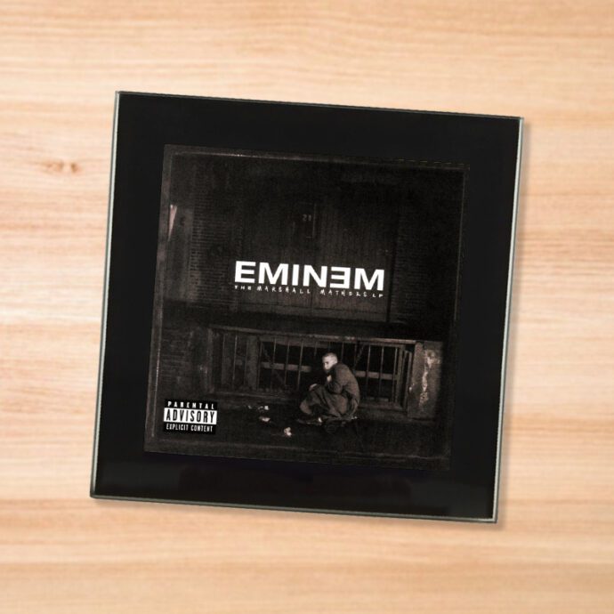 Black glass Eminem - Marshall Mathers LP coaster on a wood table
