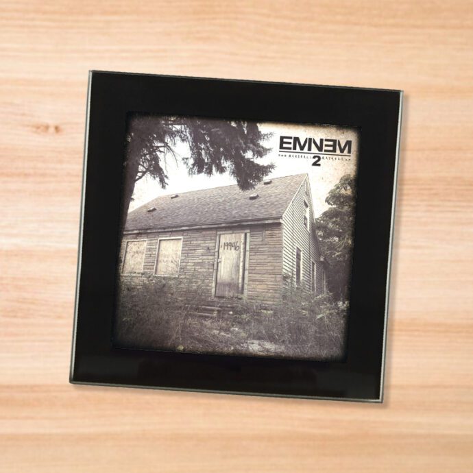 Black glass Eminem - Marshall Mathers LP 2 coaster on a wood table