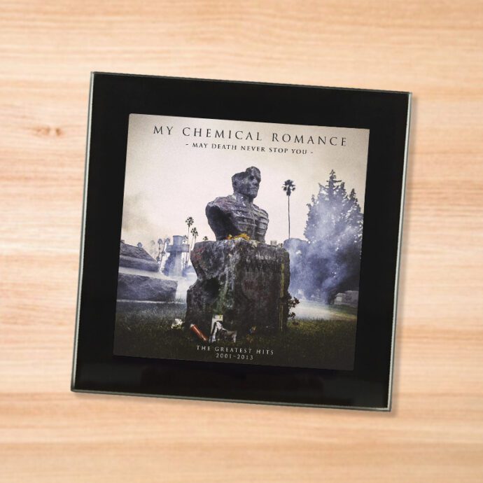 Black glass My Chemical Romance - May Death Never Stop You coaster on a wood table