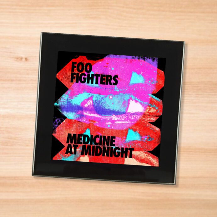 Black glass Foo Fighters - Medicine at Midnight coaster on a wood table