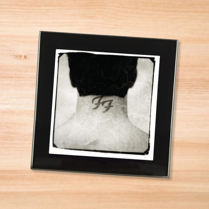 Black glass Foo Fighters - Nothing Left To Lose coaster on a wood table