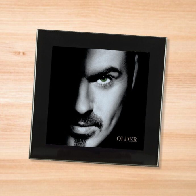 Black glass George Michael - Older coaster on a wood table