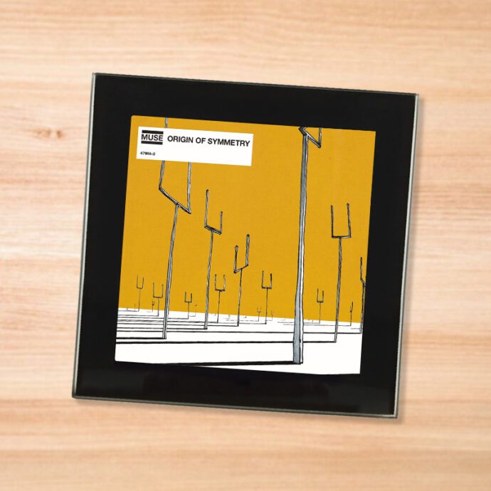 Black glass Muse - Origin of Symmetry coaster on a wood table